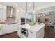 Open-concept view of a kitchen with an island, stainless appliances, and adjacent living area at 3332 Old Concord Se Rd, Smyrna, GA 30082