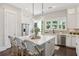 Bright kitchen features an island with counter seating and pendant lights at 3332 Old Concord Se Rd, Smyrna, GA 30082