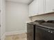 Laundry room with sleek appliances and white cabinetry at 3332 Old Concord Se Rd, Smyrna, GA 30082