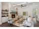 Bright living room with a brick fireplace, beamed ceilings, and an open layout to the entrance at 3332 Old Concord Se Rd, Smyrna, GA 30082