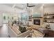 Spacious living room with a brick fireplace, built-in shelving, and an open layout to the kitchen at 3332 Old Concord Se Rd, Smyrna, GA 30082