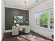 Stylish home office featuring a modern desk, a large window with a view, and hardwood floors at 3332 Old Concord Se Rd, Smyrna, GA 30082