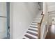 Elegant staircase with dark wood treads, white risers, and a stylish wood railing at 3332 Old Concord Se Rd, Smyrna, GA 30082