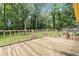 Spacious wooden deck with backyard view surrounded by lush trees and vegetation at 574 Horseshoe Sw Cir, Lilburn, GA 30047