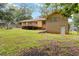 Spacious backyard featuring home and back deck with mature shade trees and lush green grass at 574 Horseshoe Sw Cir, Lilburn, GA 30047