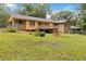 Beautiful backyard featuring home and deck with blue hydrangeas and lush green grass at 574 Horseshoe Sw Cir, Lilburn, GA 30047