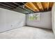 Unfinished basement space with concrete floor, light grey walls, and double-hung window at 574 Horseshoe Sw Cir, Lilburn, GA 30047