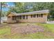 Single-story home with traditional brickwork, black shutters, and a well-maintained front yard at 574 Horseshoe Sw Cir, Lilburn, GA 30047