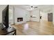 Bright living room features a cozy fireplace, hardwood floors, and a seamless flow into the kitchen at 574 Horseshoe Sw Cir, Lilburn, GA 30047