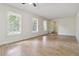 Expansive living room with beautiful hardwood floors, large windows, and neutral paint, offering ample natural light at 574 Horseshoe Sw Cir, Lilburn, GA 30047