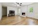 Open-concept living room boasts hardwood floors, a cozy fireplace, and easy access to the outdoors at 574 Horseshoe Sw Cir, Lilburn, GA 30047