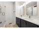Modern bathroom with double vanity, gold fixtures, and a glass-enclosed shower, creating a spa-like feel at 988 Viney Nw Way, Atlanta, GA 30318