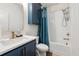 Charming bathroom featuring a vanity with blue cabinets, gold fixtures, a tub, and a shower at 988 Viney Nw Way, Atlanta, GA 30318