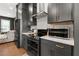 Stylish kitchen boasts dark gray cabinets, stainless steel oven and microwave, and modern countertops at 988 Viney Nw Way, Atlanta, GA 30318