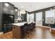 Modern kitchen features gray cabinetry, a stainless steel refrigerator, and a white countertop island with barstool seating at 988 Viney Nw Way, Atlanta, GA 30318