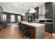 Open concept kitchen and living area is designed with sleek gray walls and modern lighting at 988 Viney Nw Way, Atlanta, GA 30318
