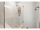 Walk-in shower featuring white tile, a glass door, built-in seating, and gold fixtures offering modern design at 988 Viney Nw Way, Atlanta, GA 30318