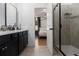 Contemporary bathroom featuring a large vanity with quartz countertops, a glass-enclosed shower and view to bedroom at 2673 Caruso Way, Atlanta, GA 30339