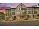 Modern townhome complex with gray siding, brick accents, and well-manicured landscaping at 2673 Caruso Way, Atlanta, GA 30339