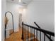 Hallway featuring a modern mirror, staircase, and hardwood floors at 2673 Caruso Way, Atlanta, GA 30339