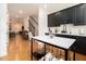 Open-concept kitchen featuring dark cabinets, white countertops and wood flooring at 2673 Caruso Way, Atlanta, GA 30339