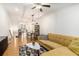 Cozy living room with a stylish yellow sofa, geometric rug, and hardwood floors at 2673 Caruso Way, Atlanta, GA 30339