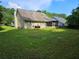 View of a large backyard with plenty of green grass and trees in the background at 7073 Stonecreek Dr, Douglasville, GA 30134
