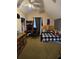 Cozy bedroom with sloped ceiling, a wooden bed, and a carpeted floor at 7073 Stonecreek Dr, Douglasville, GA 30134