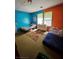Cozy bedroom featuring colorful walls, large windows, and comfortable sleeping arrangements at 7073 Stonecreek Dr, Douglasville, GA 30134