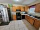 Efficient kitchen features stainless steel appliances, tile floors, and wood cabinetry at 7073 Stonecreek Dr, Douglasville, GA 30134