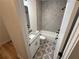 Charming bathroom with patterned tile flooring, a tub-shower combo, and a modern vanity at 72 Hanover Dr, Villa Rica, GA 30180