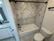 Bathroom featuring a white tub and gray marble tile at 72 Hanover Dr, Villa Rica, GA 30180