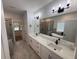 Spa-like bathroom with dual vanities, a soaking tub, a tiled shower, and sleek modern fixtures at 72 Hanover Dr, Villa Rica, GA 30180