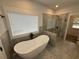 Bright bathroom with a freestanding tub, a separate shower, and stylish tilework at 72 Hanover Dr, Villa Rica, GA 30180