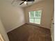 Bedroom featuring neutral carpeting and a large window at 72 Hanover Dr, Villa Rica, GA 30180