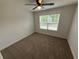 This cozy bedroom has a ceiling fan and natural light from the window at 72 Hanover Dr, Villa Rica, GA 30180