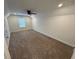 Carpeted bedroom with ceiling fan and natural light at 72 Hanover Dr, Villa Rica, GA 30180