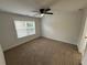 Bedroom featuring neutral carpet, ceiling fan, and window at 72 Hanover Dr, Villa Rica, GA 30180