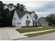 Charming two-story home with a manicured lawn and a spacious driveway at 72 Hanover Dr, Villa Rica, GA 30180