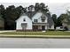 Beautiful two-story home with a manicured lawn and a concrete driveway with a service van in view at 72 Hanover Dr, Villa Rica, GA 30180