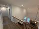 Bright foyer with wood floors, iron railing, and modern lighting at 72 Hanover Dr, Villa Rica, GA 30180