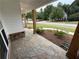 Inviting front porch with decorative stone pillars and flagstone flooring for a rustic, elegant entrance at 72 Hanover Dr, Villa Rica, GA 30180