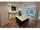 Modern kitchen featuring a large island, stainless steel appliances, custom cabinetry, and hardwood flooring at 72 Hanover Dr, Villa Rica, GA 30180