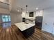 Modern kitchen with an oversized island, stainless steel appliances, and custom cabinetry at 72 Hanover Dr, Villa Rica, GA 30180