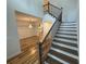 Hardwood staircase leading to the second floor with natural light and wrought iron at 72 Hanover Dr, Villa Rica, GA 30180
