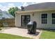 Backyard featuring a patio area with a grill and green lawn with a basketball hoop nearby at 784 Crestworth Xing, Powder Springs, GA 30127