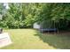 Large backyard, with a shed, trampoline, and a patio at 784 Crestworth Xing, Powder Springs, GA 30127