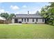 Home displaying a large backyard with green grass, perfect for outdoor activities and relaxation at 784 Crestworth Xing, Powder Springs, GA 30127