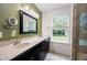 Bathroom with a large double sink vanity, and natural light from the window, plus a walk-in tiled shower at 784 Crestworth Xing, Powder Springs, GA 30127