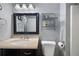 Bathroom features a vanity with dark wood cabinets, a bright mirror, and silver fixtures at 784 Crestworth Xing, Powder Springs, GA 30127